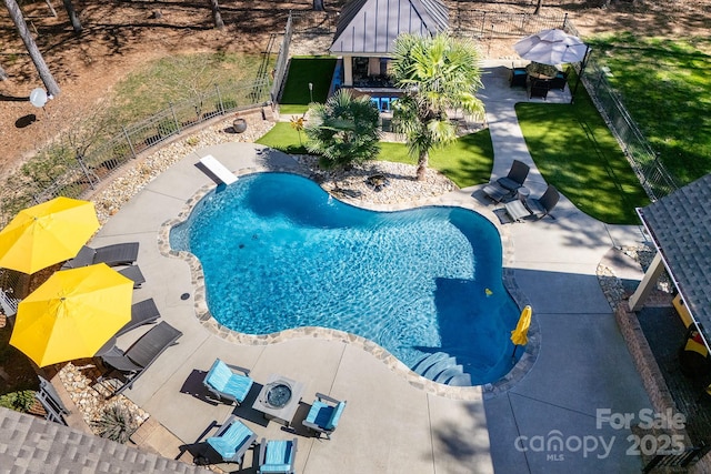 view of swimming pool featuring fence, a fenced in pool, and a patio area