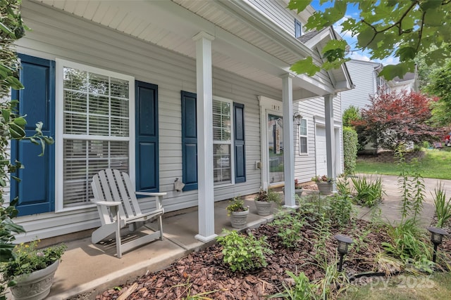 1017 Chalk Hill Ln, Charlotte, NC 28214 - doorway to property with covered porch and an attached garage