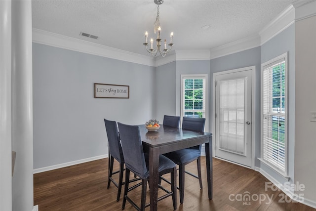 1017 Chalk Hill Ln, Charlotte, NC 28214 - dining room featuring a chandelier, dark wood-style floors, ornamental molding, a textured ceiling, and baseboards