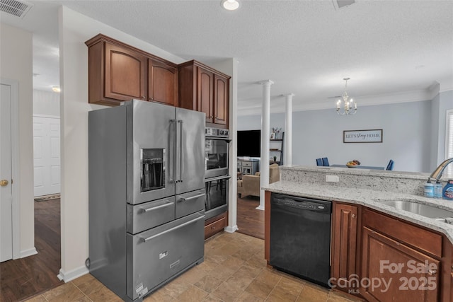 1017 Chalk Hill Ln, Charlotte, NC 28214 - kitchen featuring stainless steel appliances, a sink, light stone countertops, ornamental molding, and a chandelier