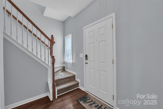 1017 Chalk Hill Ln, Charlotte, NC 28214 - entryway with dark wood-type flooring, stairs, and baseboards