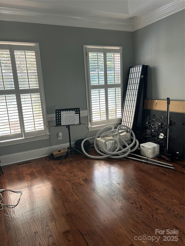1308 Moonshadow Ln, Shelby, NC 28150 - miscellaneous room with crown molding, wood finished floors, visible vents, and a healthy amount of sunlight