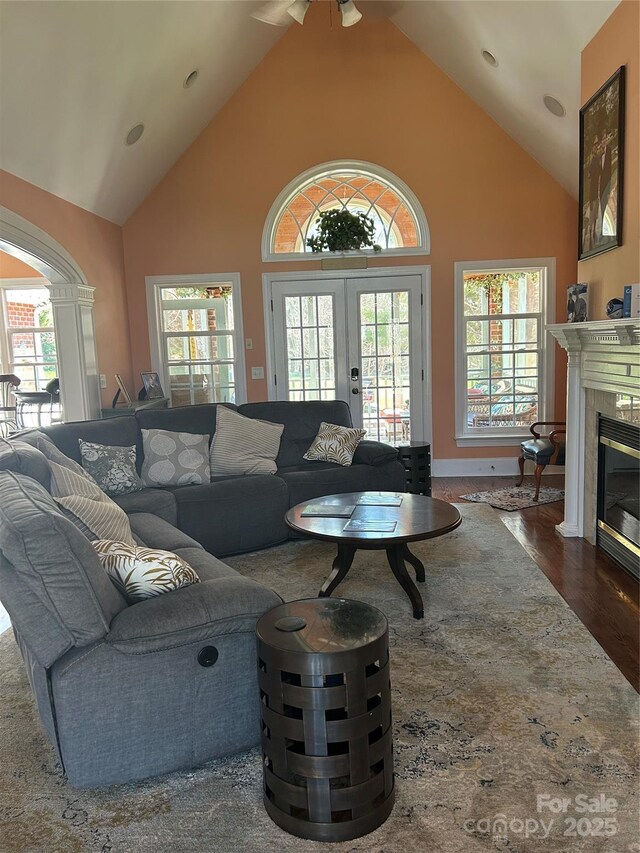 1308 Moonshadow Ln, Shelby, NC 28150 - living area with french doors, a fireplace with flush hearth, high vaulted ceiling, and dark wood finished floors