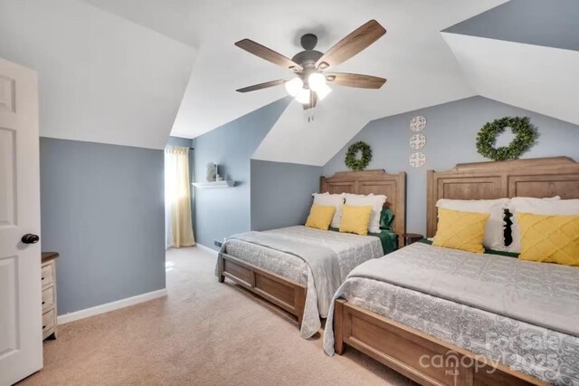 bedroom with light carpet, baseboards, vaulted ceiling, and ceiling fan