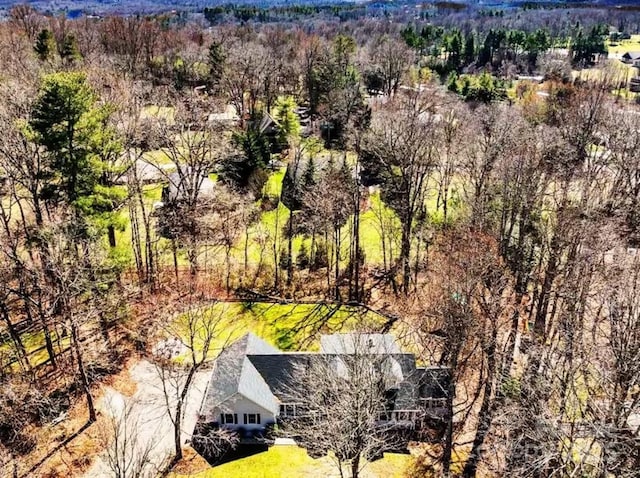 birds eye view of property with a view of trees