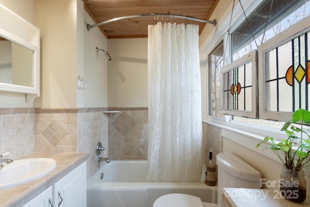 1506 Lynn Rd, Columbus, NC 28722 - bathroom with healthy amount of natural light, shower / bath combo, vanity, tile walls, and wainscoting