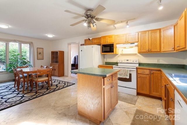 1506 Lynn Rd, Columbus, NC 28722 - kitchen featuring white appliances, under cabinet range hood, a kitchen island, dark countertops, and track lighting