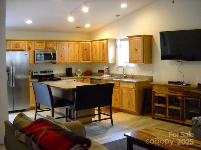 992 Hornet Dr, Whittier, NC 28789 - kitchen with stainless steel appliances, recessed lighting, a sink, light wood-style floors, and vaulted ceiling