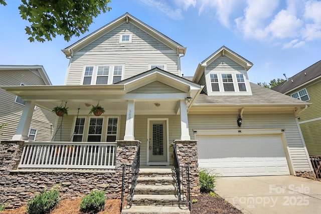 5807 Mctaggart Ln, Charlotte, NC 28269 - view of front facade featuring a porch, concrete driveway, and an attached garage