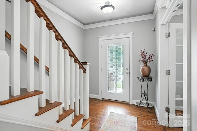 5807 Mctaggart Ln, Charlotte, NC 28269 - foyer with stairway, wood finished floors, and ornamental molding