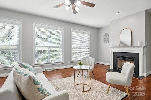 5807 Mctaggart Ln, Charlotte, NC 28269 - living area featuring a ceiling fan, a glass covered fireplace, and wood finished floors