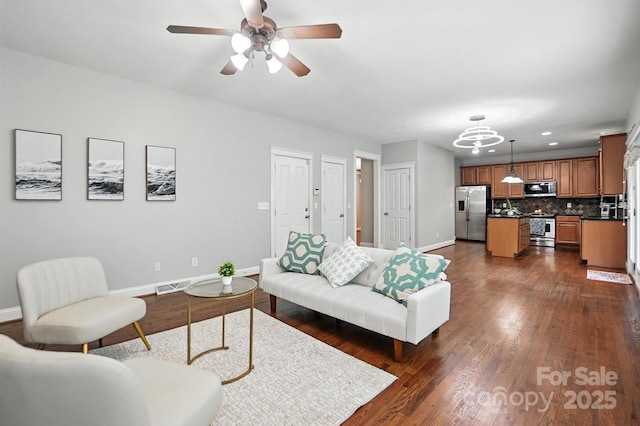 5807 Mctaggart Ln, Charlotte, NC 28269 - living room featuring recessed lighting, dark wood-style floors, a chandelier, and ceiling fan