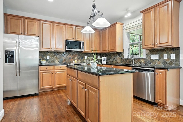 5807 Mctaggart Ln, Charlotte, NC 28269 - kitchen featuring stainless steel appliances, dark wood-type flooring, a center island, dark stone counters, and backsplash