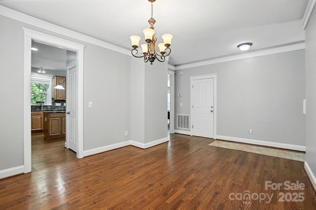 5807 Mctaggart Ln, Charlotte, NC 28269 - empty room with a chandelier, dark wood-type flooring, and crown molding