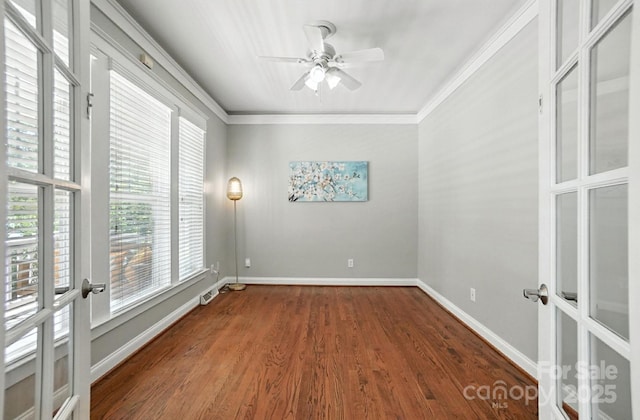 5807 Mctaggart Ln, Charlotte, NC 28269 - empty room featuring healthy amount of natural light, wood finished floors, a ceiling fan, crown molding, and french doors