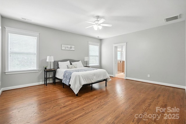 5807 Mctaggart Ln, Charlotte, NC 28269 - bedroom featuring wood finished floors, ceiling fan, and connected bathroom