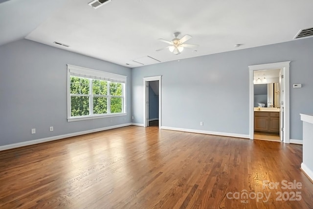 5807 Mctaggart Ln, Charlotte, NC 28269 - unfurnished living room with a ceiling fan, wood finished floors, and vaulted ceiling