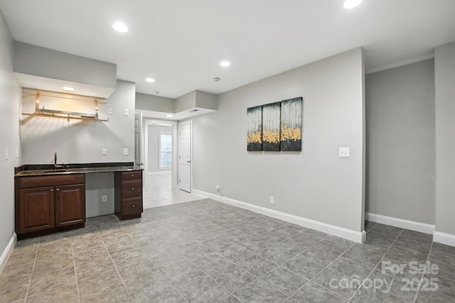 5807 Mctaggart Ln, Charlotte, NC 28269 - kitchen with light tile patterned flooring, recessed lighting, dark countertops, and dark brown cabinetry