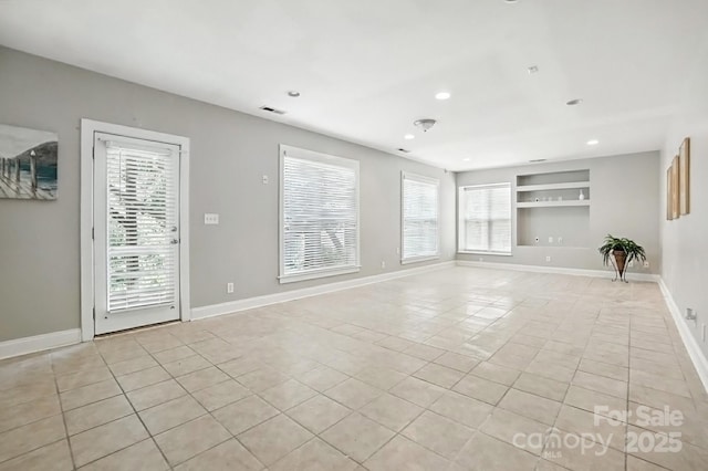 5807 Mctaggart Ln, Charlotte, NC 28269 - spare room with light tile patterned flooring, built in features, and recessed lighting