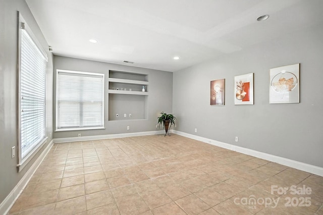 5807 Mctaggart Ln, Charlotte, NC 28269 - spare room featuring built in features, recessed lighting, and light tile patterned floors