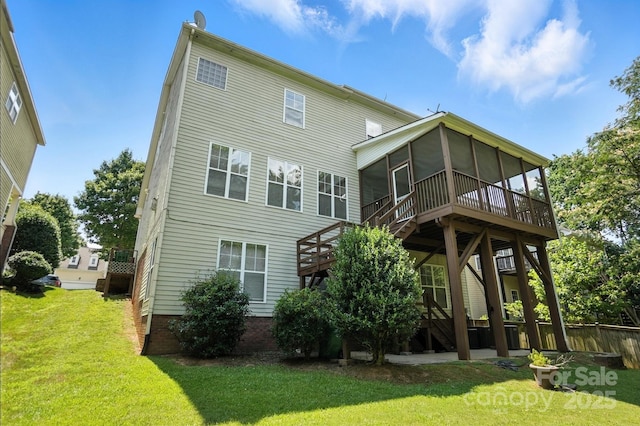 5807 Mctaggart Ln, Charlotte, NC 28269 - rear view of house with a sunroom, a lawn, a wooden deck, and stairs
