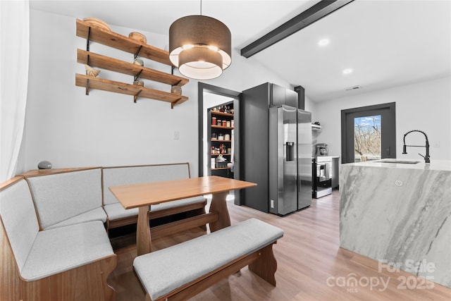 5501 Joyce Dr, Charlotte, NC 28215 - dining area with beamed ceiling, light wood-style floors, and recessed lighting