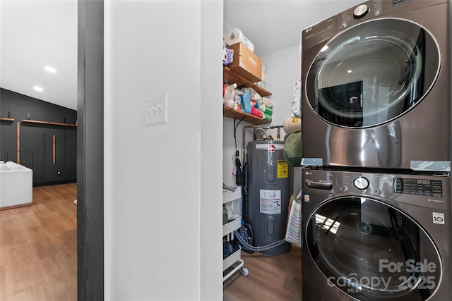 5501 Joyce Dr, Charlotte, NC 28215 - laundry room with stacked washer / drying machine, water heater, and wood finished floors