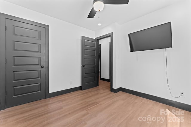 5501 Joyce Dr, Charlotte, NC 28215 - unfurnished bedroom with light wood-style floors, baseboards, and ceiling fan