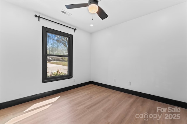 5501 Joyce Dr, Charlotte, NC 28215 - empty room with wood finished floors, baseboards, and a ceiling fan