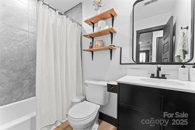 5501 Joyce Dr, Charlotte, NC 28215 - bathroom featuring toilet, vanity, shower / bath combo, and wood finished floors