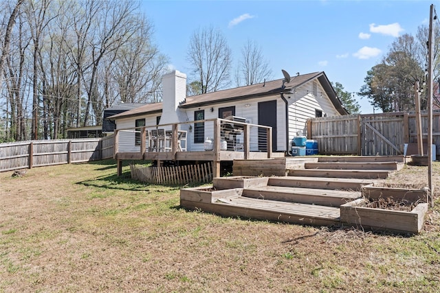 5501 Joyce Dr, Charlotte, NC 28215 - rear view of property with a wooden deck, a garden, and a chimney
