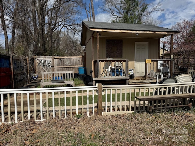 exterior space with a front yard, a fenced backyard, and a wooden deck