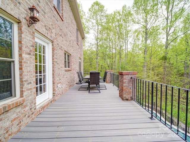 wooden deck featuring outdoor dining area