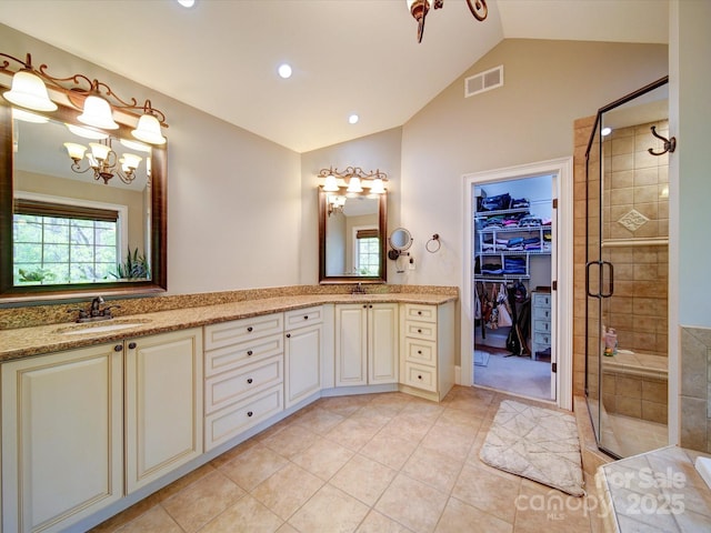 full bath featuring visible vents, a sink, vaulted ceiling, and a stall shower