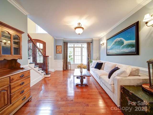 living room with a healthy amount of sunlight, crown molding, and wood finished floors