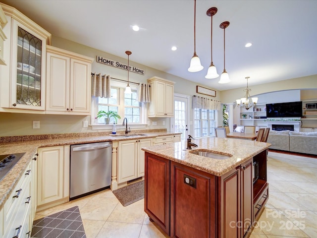 kitchen with cream cabinetry, an inviting chandelier, a sink, and dishwasher