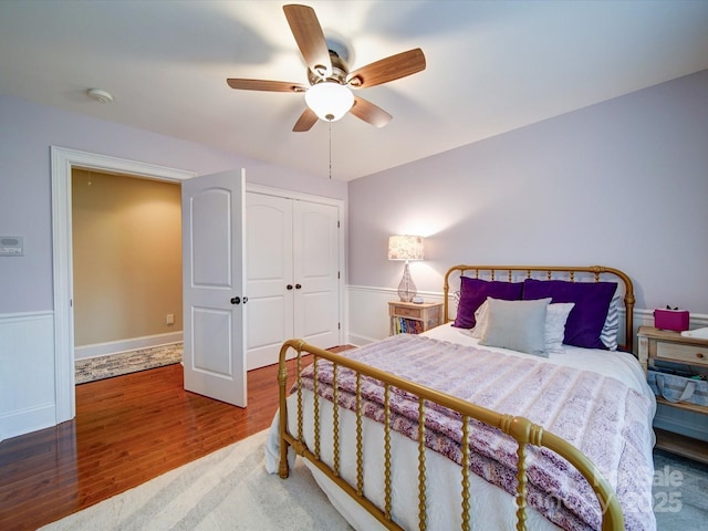 bedroom with ceiling fan, a closet, and wood finished floors