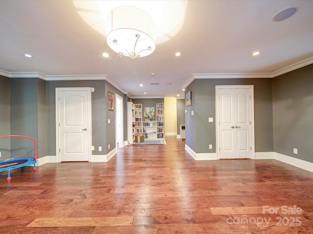 interior space with recessed lighting, ornamental molding, and wood finished floors