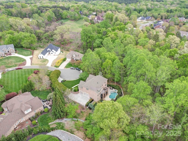 aerial view with a residential view and a view of trees