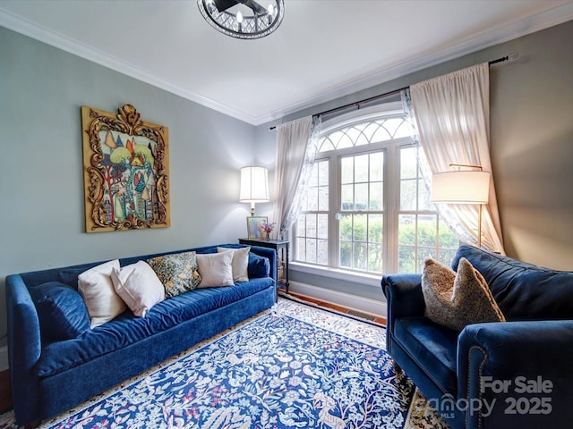 living room featuring crown molding, baseboards, visible vents, and wood finished floors