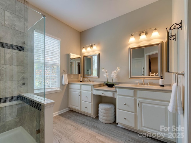 9607 Kestral Ridge Dr, Charlotte, NC 28269 - bathroom with double vanity, a shower stall, and wood finished floors