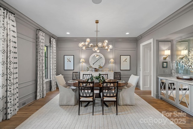 19117 Davidson Concord Rd, Davidson, NC 28036 - dining room featuring a decorative wall, crown molding, a chandelier, wood finished floors, and recessed lighting