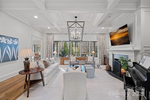 19117 Davidson Concord Rd, Davidson, NC 28036 - living room with coffered ceiling, beam ceiling, a lit fireplace, light wood-style flooring, and a chandelier