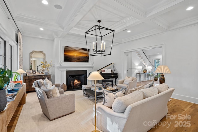 19117 Davidson Concord Rd, Davidson, NC 28036 - living area with coffered ceiling, crown molding, light wood finished floors, a warm lit fireplace, and beamed ceiling