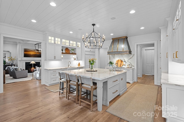 19117 Davidson Concord Rd, Davidson, NC 28036 - kitchen with premium range hood, recessed lighting, a kitchen island, backsplash, and white cabinetry