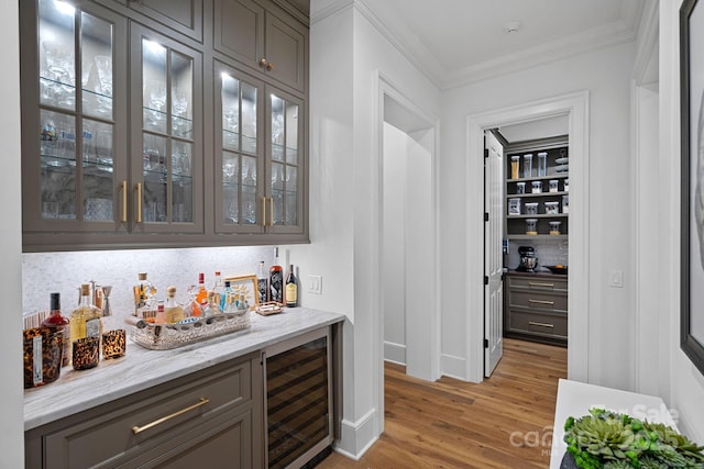19117 Davidson Concord Rd, Davidson, NC 28036 - indoor dry bar featuring wine cooler, light wood-style flooring, backsplash, ornamental molding, and baseboards