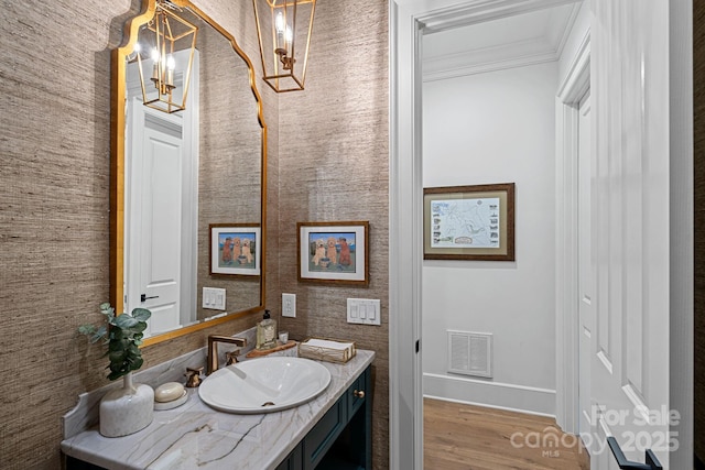 19117 Davidson Concord Rd, Davidson, NC 28036 - bathroom with baseboards, vanity, ornamental molding, wood finished floors, and a chandelier