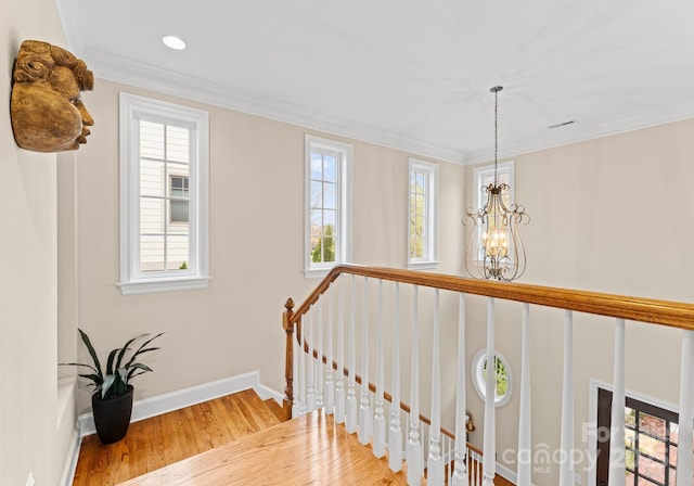 21311 Baltic Dr, Cornelius, NC 28031 - stairs with baseboards, a notable chandelier, ornamental molding, recessed lighting, and wood finished floors