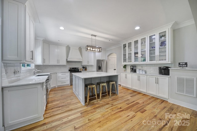 463 Lake Wylie Rd, Belmont, NC 28012 - kitchen featuring premium range hood, appliances with stainless steel finishes, white cabinets, backsplash, and ornamental molding