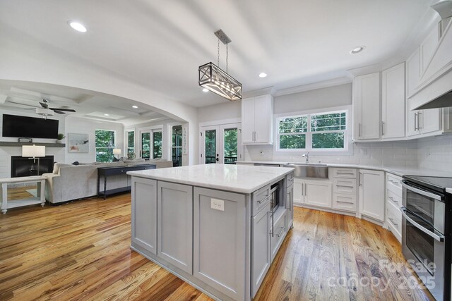 463 Lake Wylie Rd, Belmont, NC 28012 - kitchen with double oven range, a kitchen island, recessed lighting, decorative backsplash, and light wood-type flooring